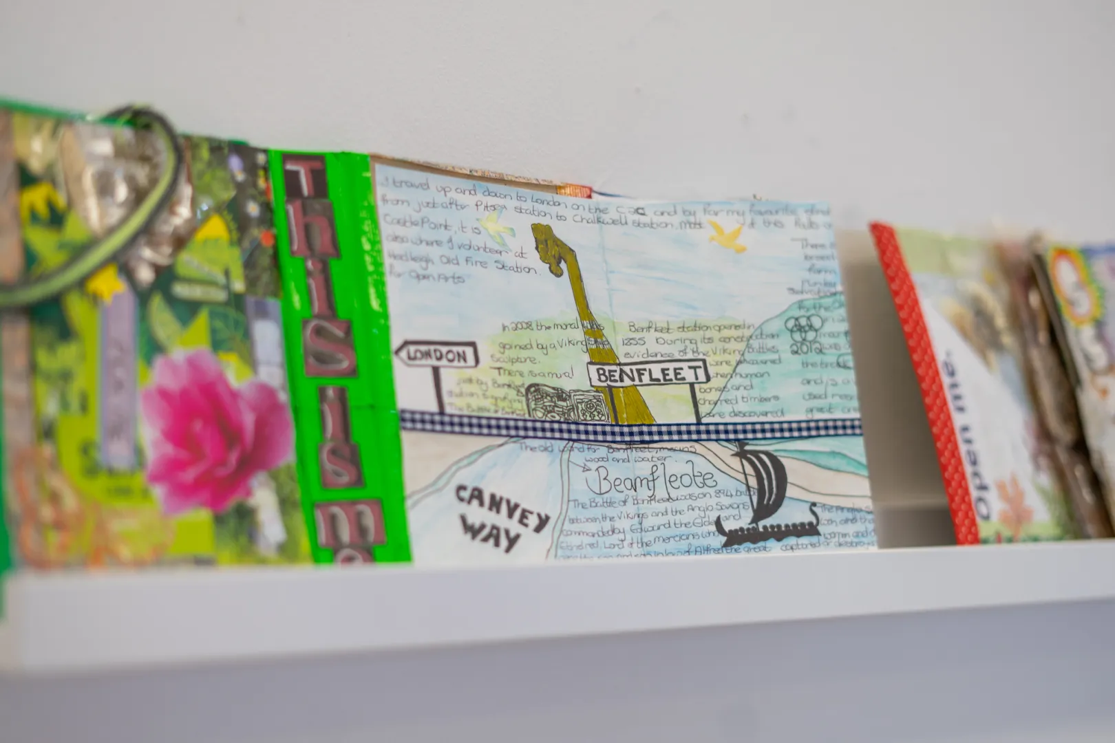 An image of a journal displayed on a white shelf