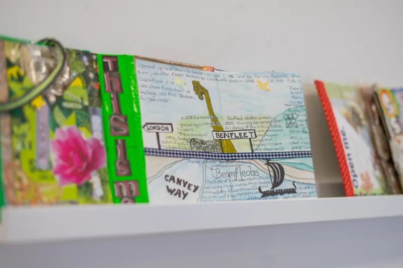 An image of a journal displayed on a white shelf